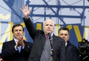U.S. Senator McCain waves to pro-European integration protesters during a mass rally at Independence Square in Kiev